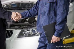 Automotive Gurukul : Businessman shaking hands with Mechanic in Auto Repair Shop